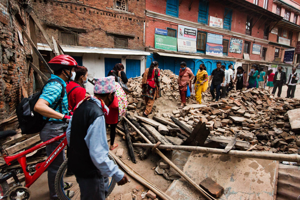 Nepalis filing through the debris near Durbar Square.